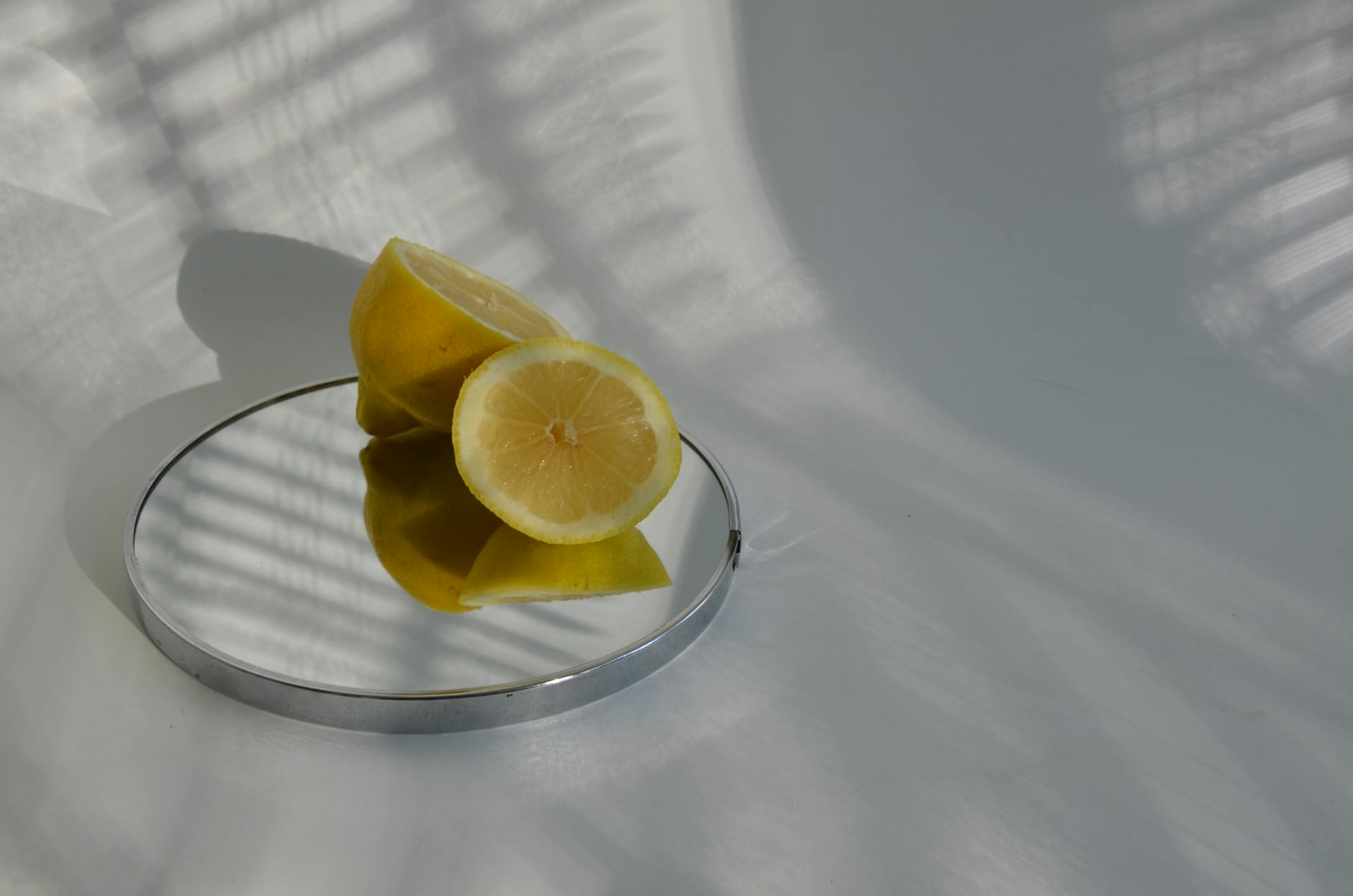 Two women smiling together with lemon slices, expressing comfort and joy