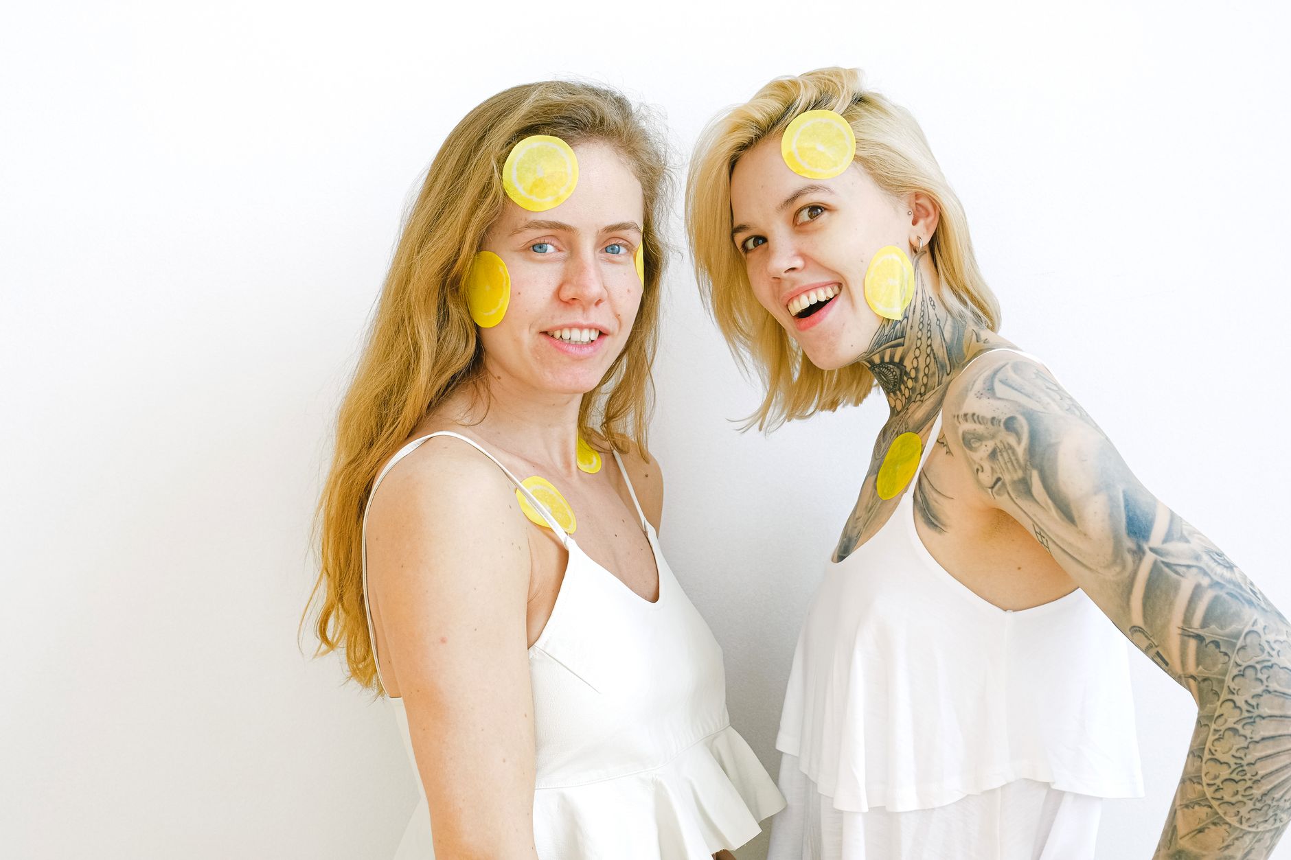 Two women laughing together while enjoying time, representing comfort and relaxation during intimate moments