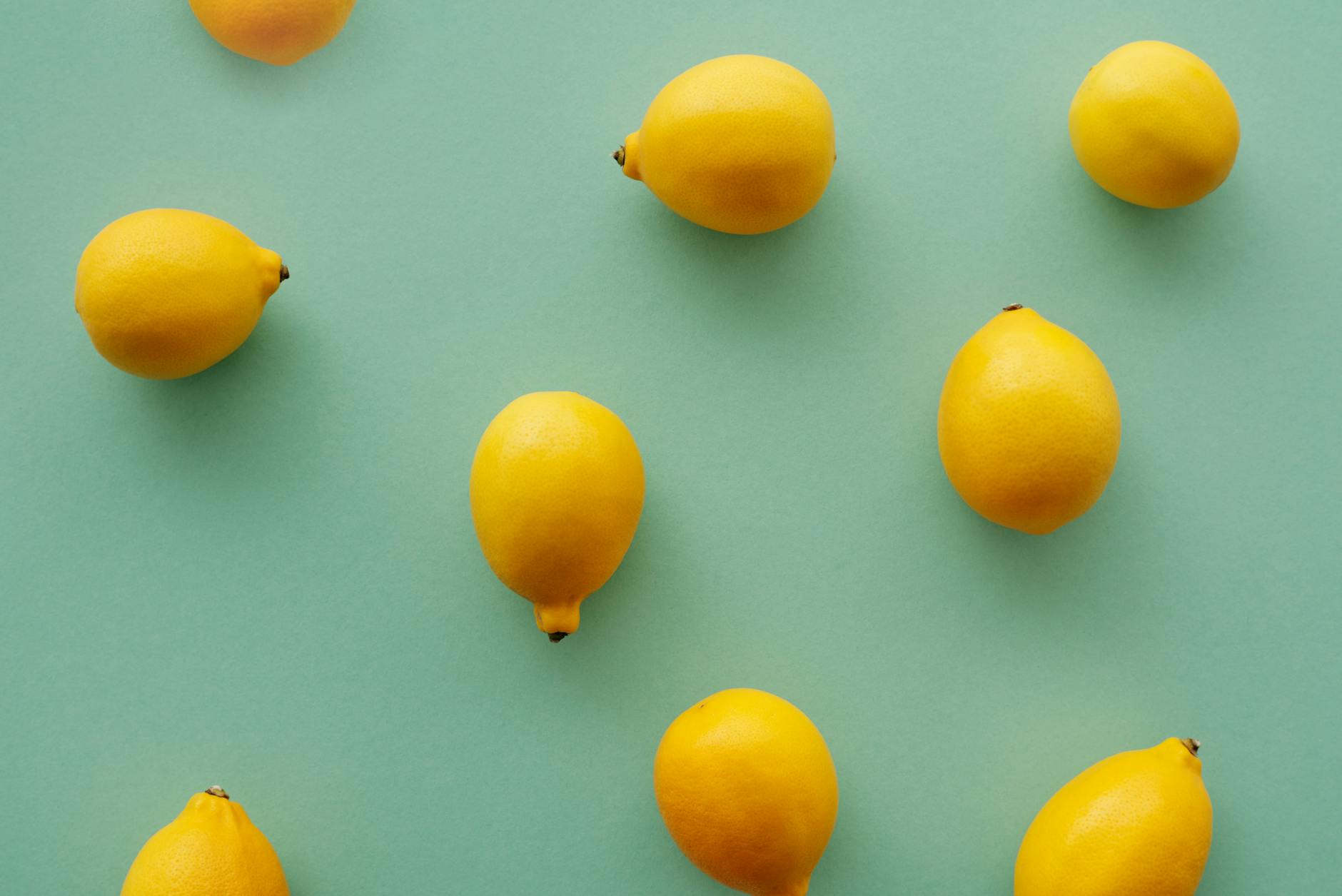 Bright yellow lemons arranged on a pastel background, symbolizing the suction technology of Hello Nancy lemon vibrators