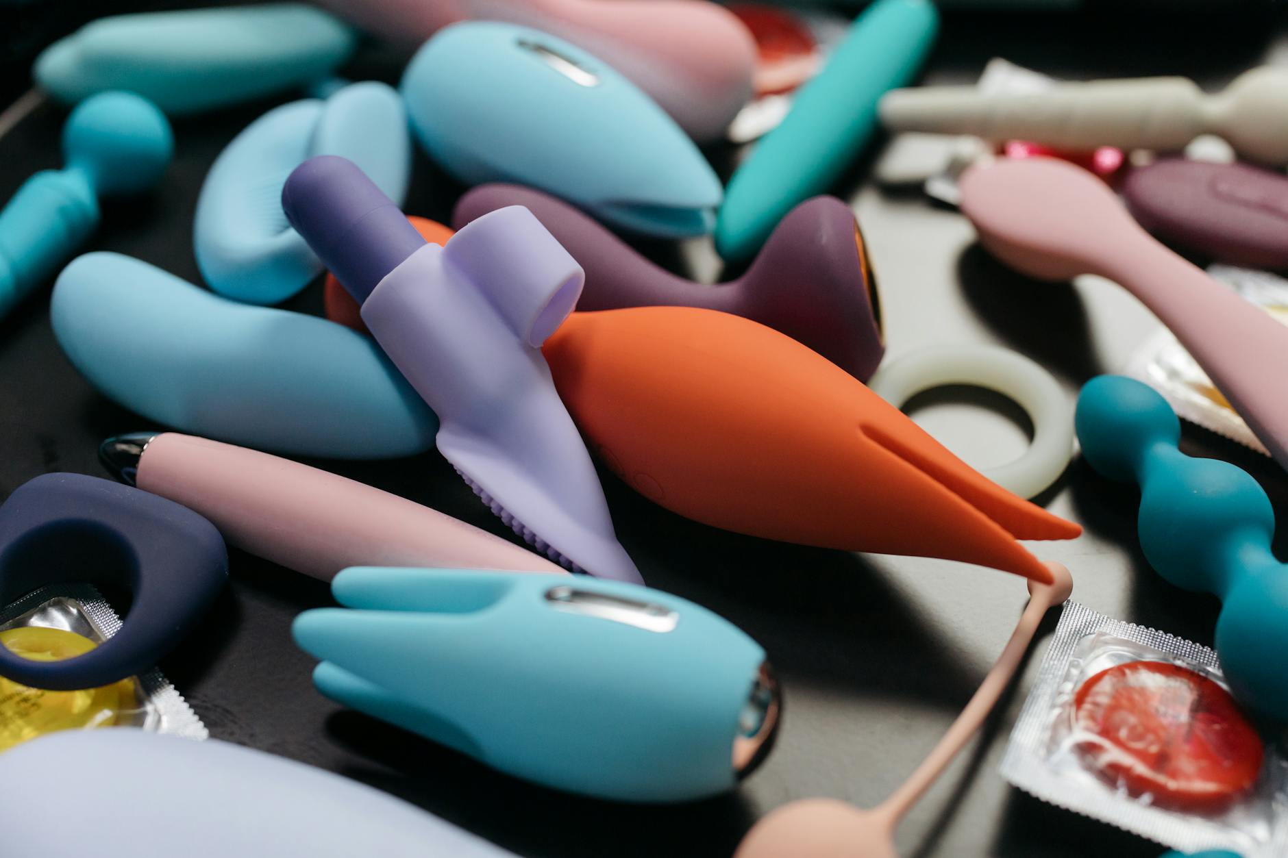 Close-up of hands holding a sleek vibrator, showcasing gentle exploration and discovery.